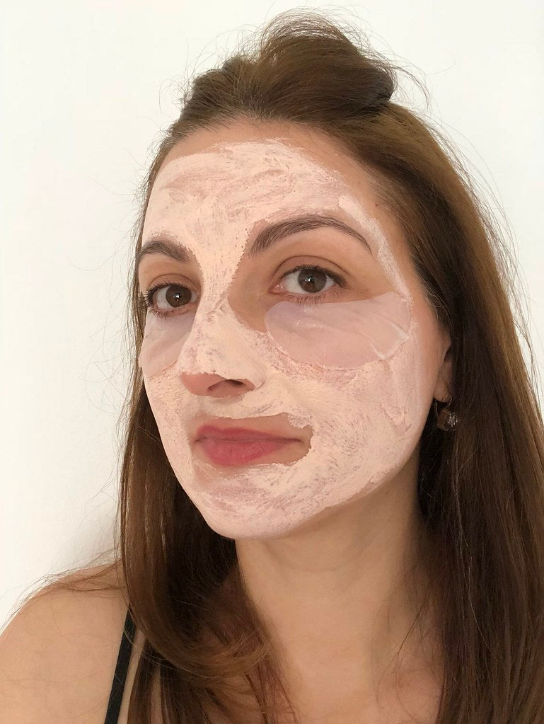 Woman applying a green clay mask to her face, demonstrating how to use clay mask properly for clearer skin.