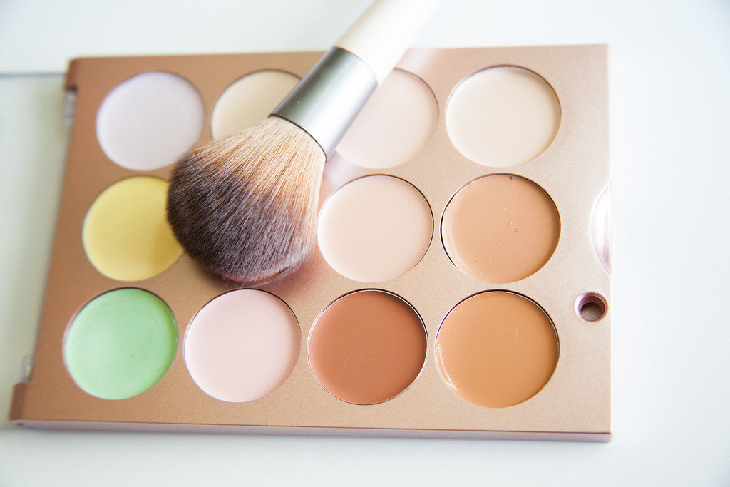 How to contour with bronzer: woman applying bronzer to cheeks with brush