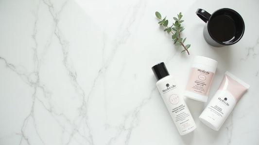 Medicube acne spot treatment products on white marble with eucalyptus