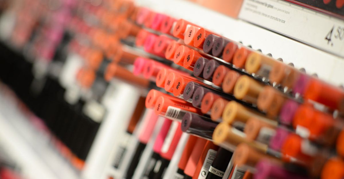 A neatly organised shelf of various beauty products representing a categories buying guide UK, including moisturisers, serums, and cleansers.