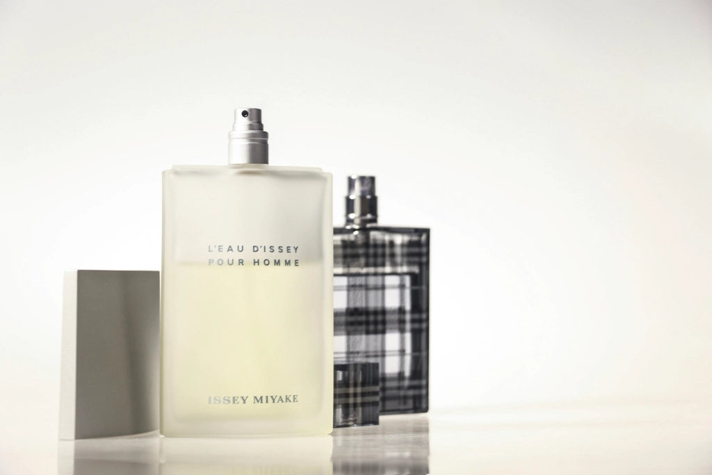 A selection of eau de toilette bottles on a bright, clean surface, illustrating how to choose eau de toilette by testing different scents.