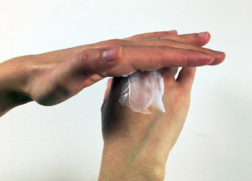 Woman applying best hand cream for dry hands UK to her hands