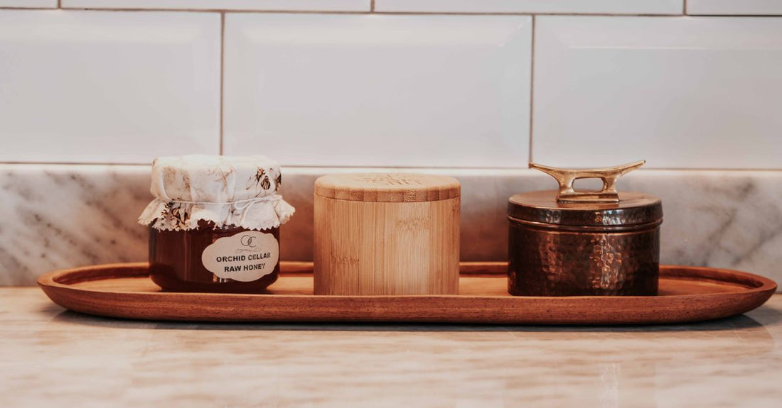 Metal canister jars on bathroom shelf for beauty storage UK