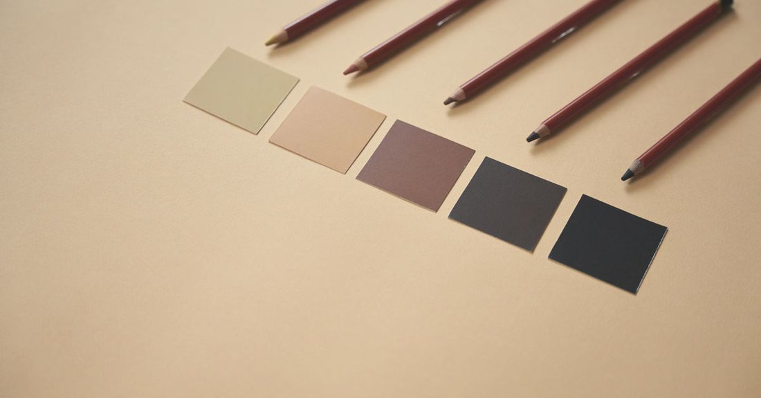 Concealers & neutralizers buying guide hero image showing a flatlay of concealer palettes and colour correctors on a marble surface.