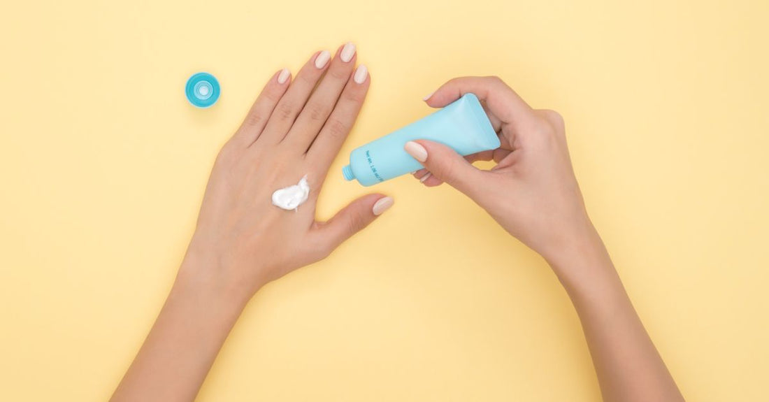 A white sunscreen bottle on a marble surface, representing the best body sunscreen for sensitive skin UK.