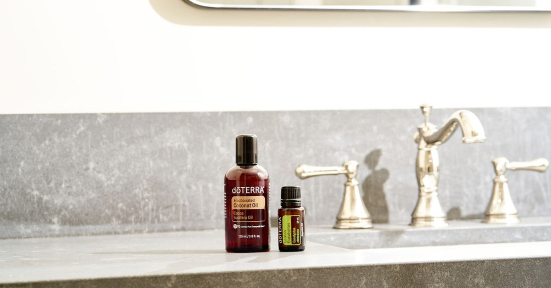 A glass bottle of pure argan oil on a white marble surface, representing the best hair oil for frizz in the UK.