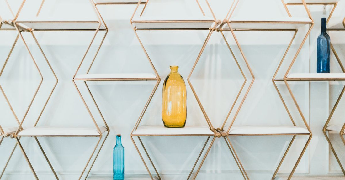 An array of conditioner bottles on a bathroom shelf, illustrating a conditioners buying guide UK for different hair types.