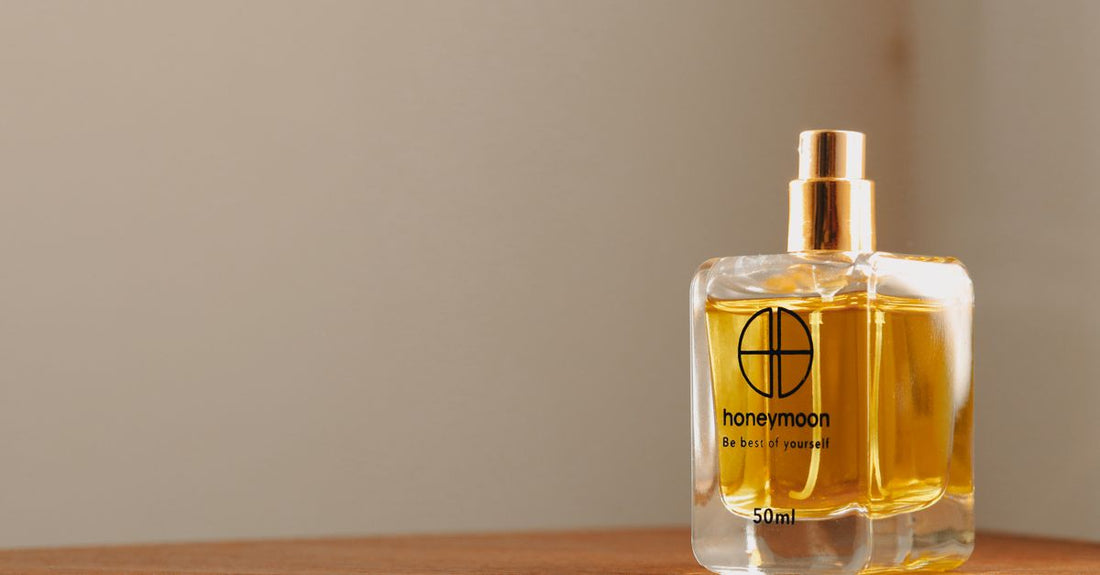 Two elegant fragrance bottles side by side on a shelf, illustrating the eau de parfum vs eau de toilette concentration difference.