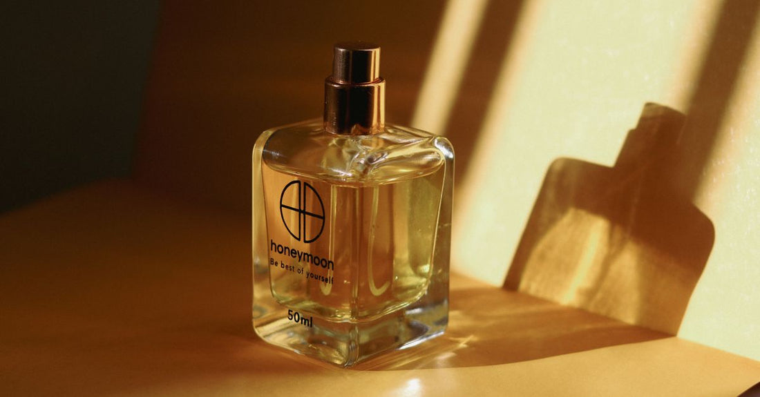 A row of elegant eau de parfum bottles on a marble surface, illustrating an eau de parfum buying guide for UK shoppers.