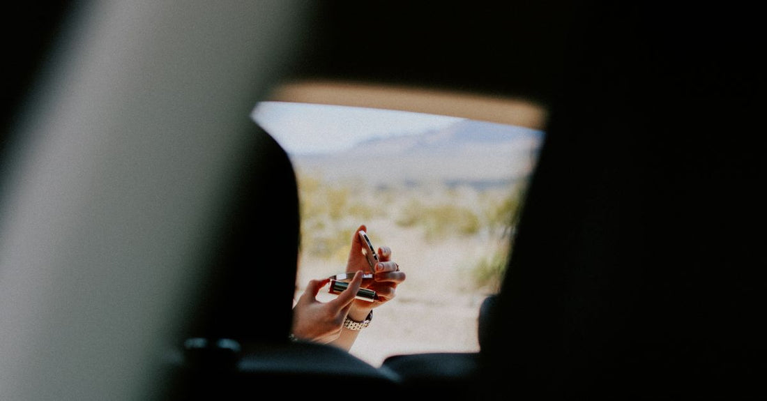 A sleek compact travel mirror resting on a marble surface, ideal for on-the-go touch-ups.