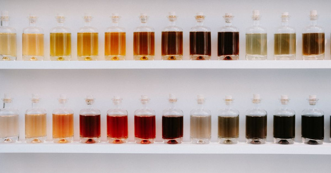 An array of perfume bottles on a surface, illustrating how to layer perfume for unique scent combinations.