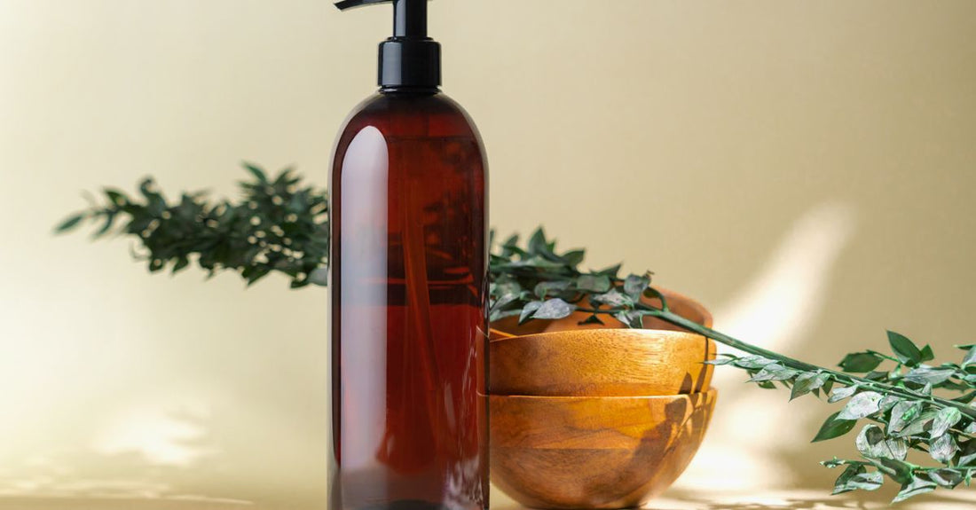 A collection of body self-tanner bottles and a tanning mitt on a marble surface, representing how to choose body self-tanners for a natural look.