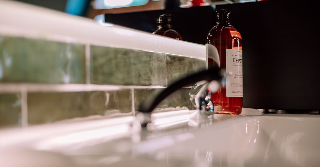An array of shampoo bottles on a bathroom shelf, illustrating how to choose shampoos UK for different hair needs.