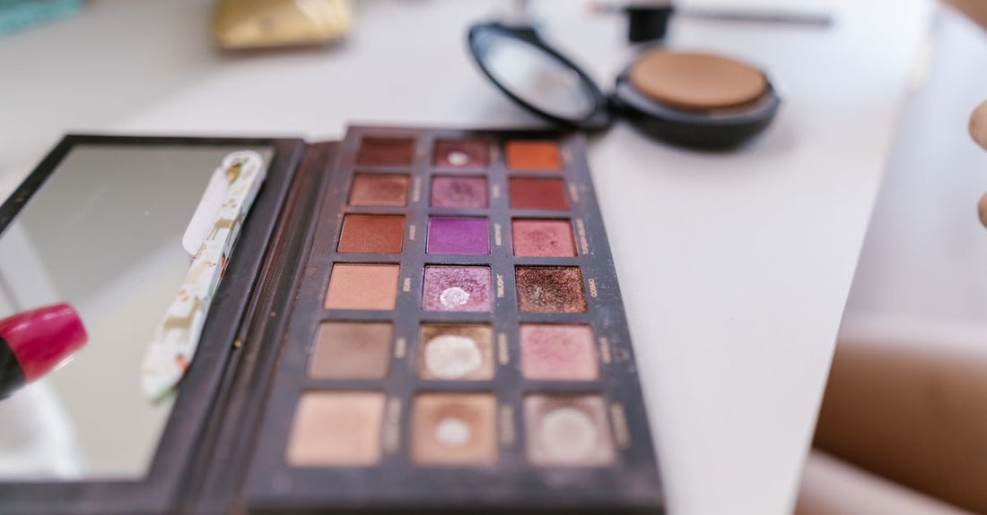 A flatlay of an eyeshadow palette with neutral matte and shimmer shades, demonstrating how to apply eyeshadow for hooded eyes.