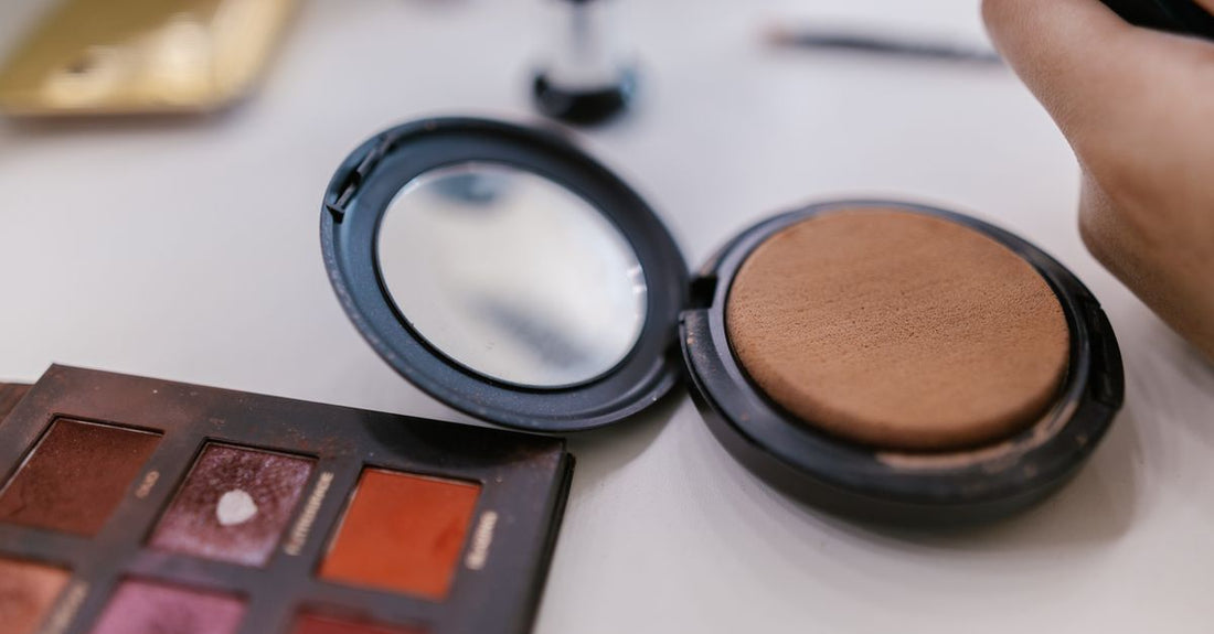 Matte bronzer compact suitable for fair skin, open to show natural tan powder, on a white background.