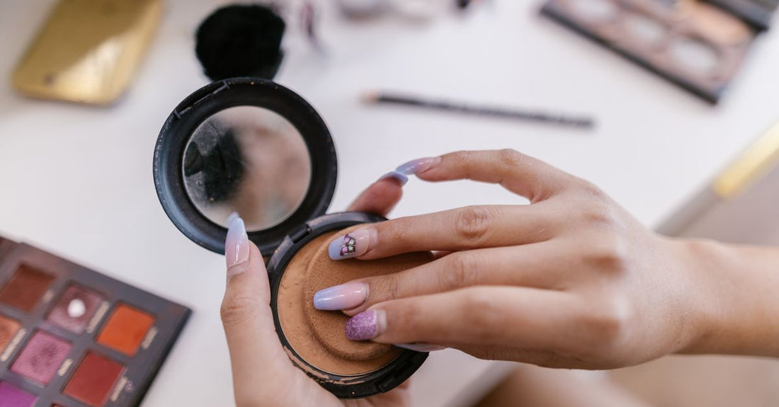 A selection of bronzer compacts on a marble surface illustrating how to choose bronzers UK for different skin tones.