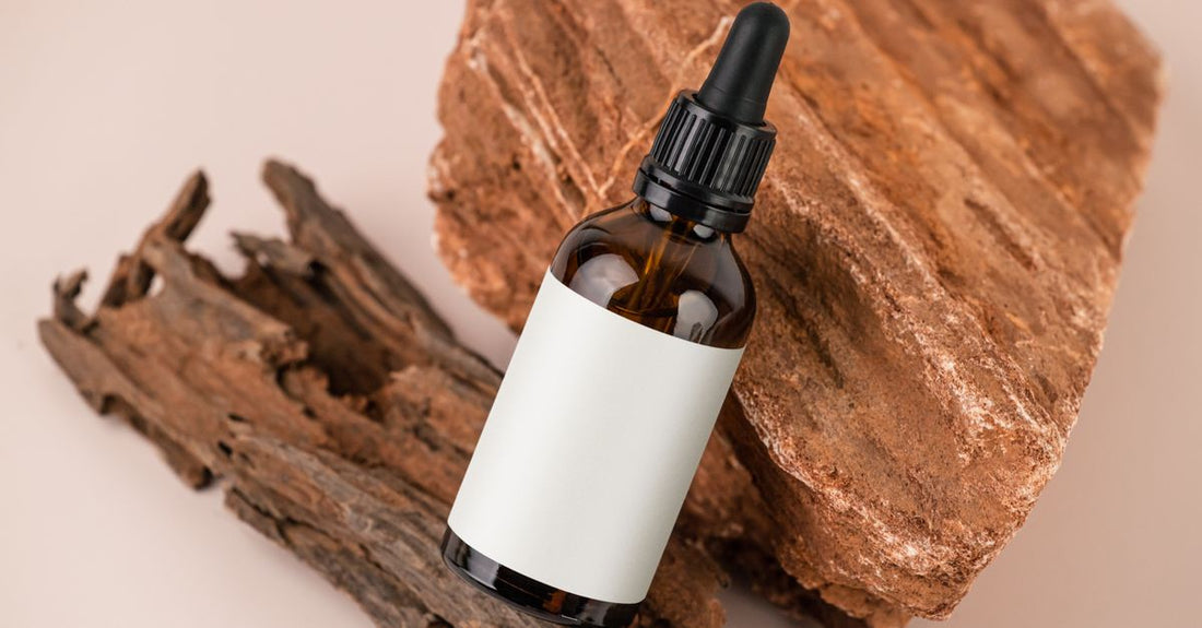 A sleek scalp treatment bottle on a marble surface, representing the best scalp treatment UK for flaky, itchy scalps.