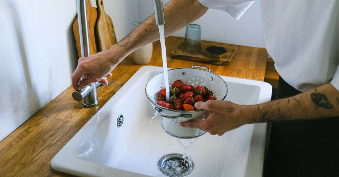 A selection of sink and shower drain strainers on a bright surface, featured in our drains & strainers buying guide.