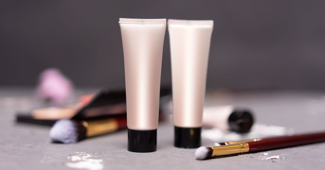 A selection of makeup primer bottles displayed on a clean flatlay surface, illustrating how to use primer for makeup longevity.