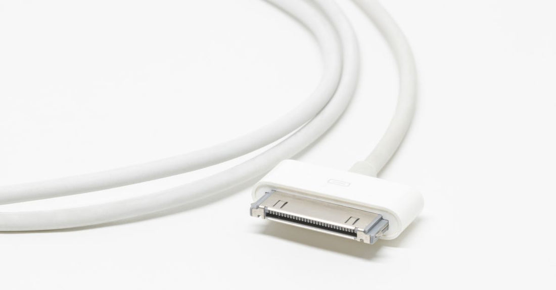 A close-up of a white USB charging cable and a compact black travel case on a clean surface, illustrating how to choose accessories for beauty devices.