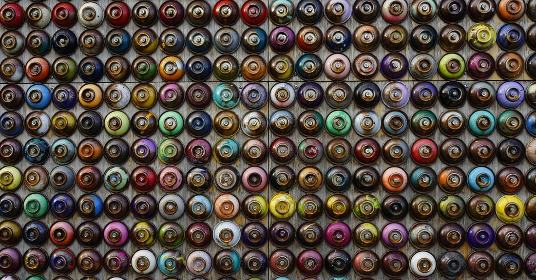 Assorted hair spray bottles in a flatlay, illustrating a hair sprays buying guide for different hold levels and finishes.