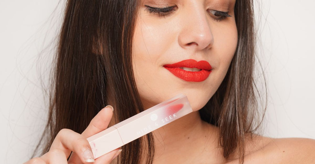 A row of shiny lip gloss tubes on a clean white surface, illustrating a lip glosses buying guide for UK shoppers.