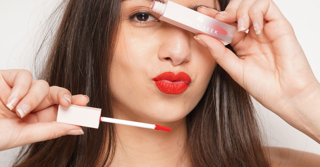 An array of the best lip glosses 2026 displayed on a white surface, showcasing various shades and glossy finishes.
