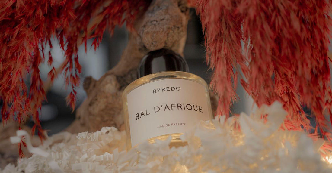 A collection of best eau de parfum 2026 bottles displayed on a marble surface, featuring elegant designs.