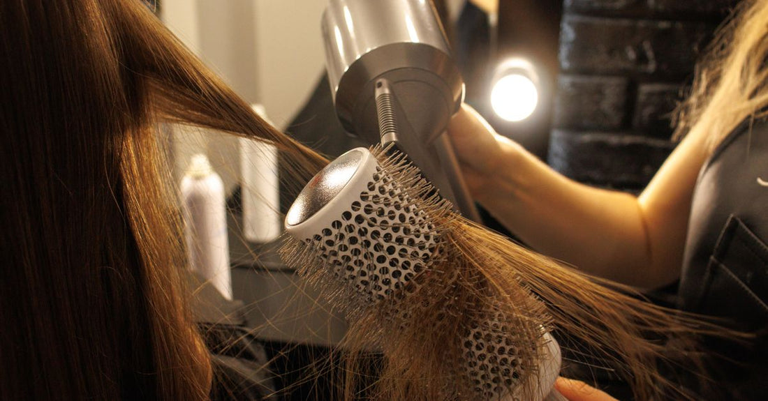 A ceramic hair straightening brush with digital temperature display on a neutral background, perfect for best hair straightening brush UK.