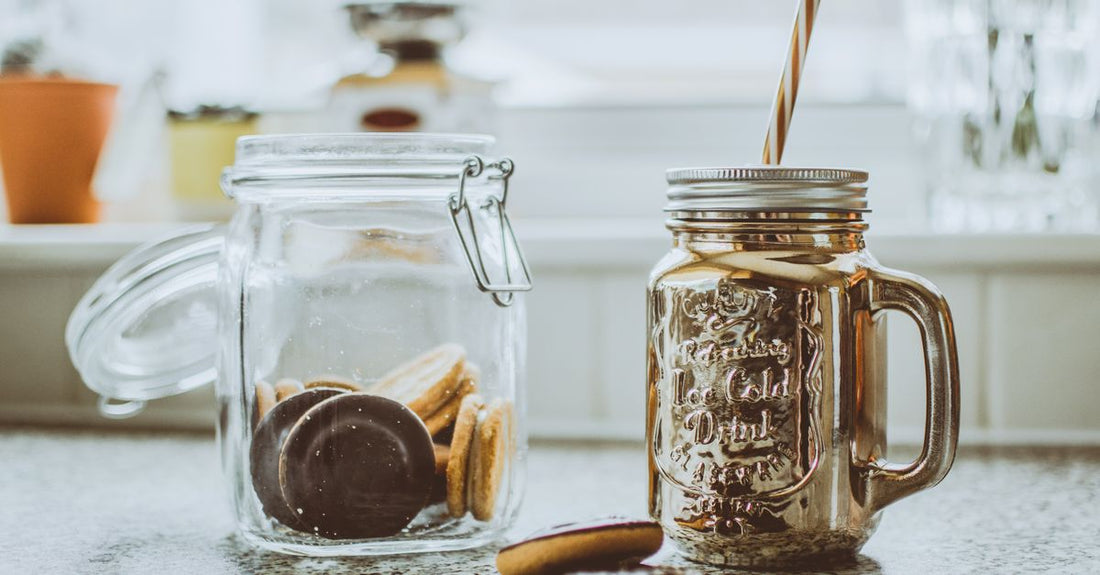 A glass jar of face cream sits on a marble surface, illustrating our creams buying guide's focus on barrier-repair ingredients.