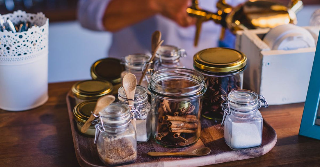 A jar of sugar body scrub with natural ingredients on a light background, representing a body scrubs buying guide