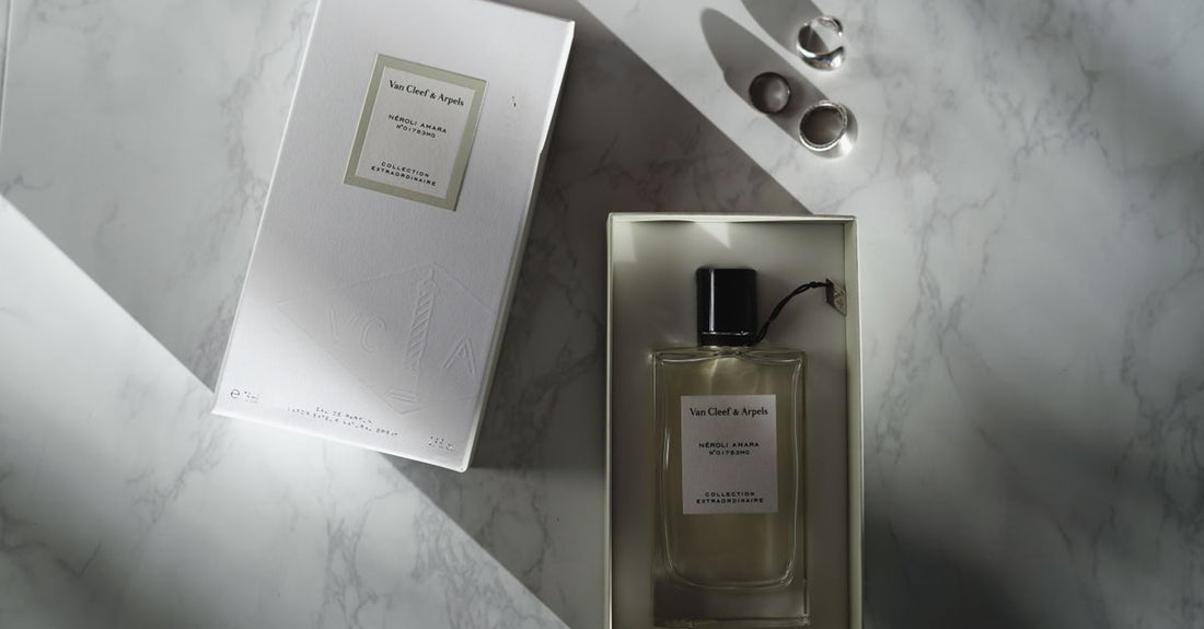 An elegant glass eau de parfum bottle on a white marble surface, illustrating our eau de parfum buying guide UK.