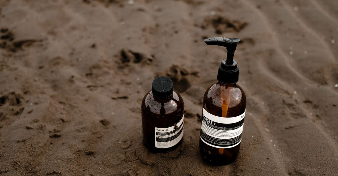 A collection of facial wash bottles on a bathroom shelf, illustrating a washes buying guide UK