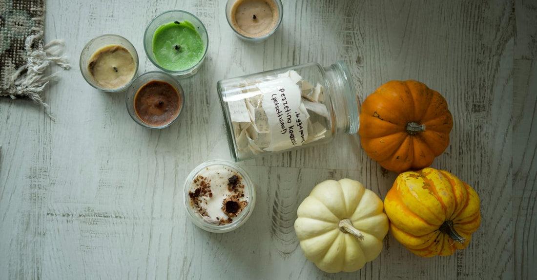 A selection of moisturisers in glass jars surrounded by autumn leaves, illustrating how to choose moisturisers for seasonal changes.