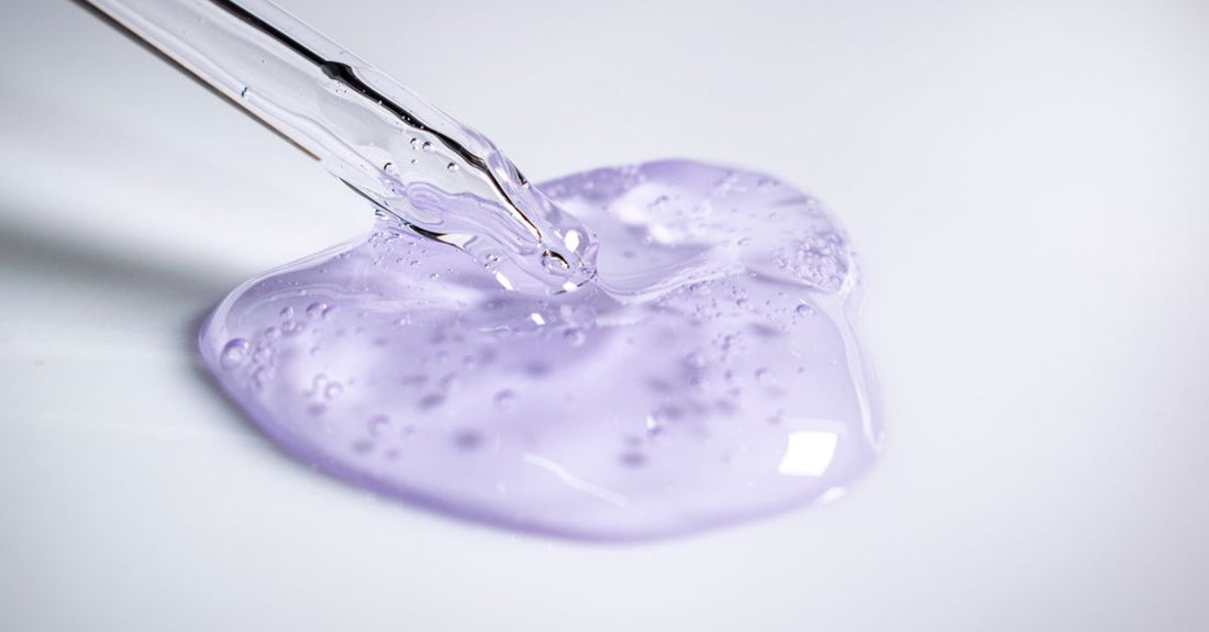 A clear brow gel tube and wand on a clean white dressing table, representing the best brow gel for fluffy brows.
