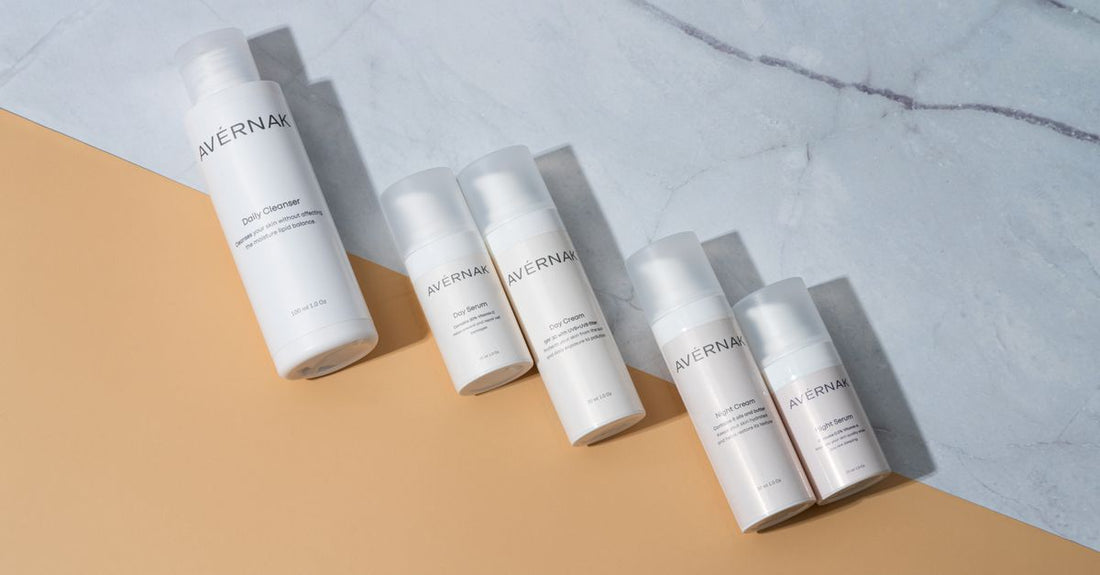 How to choose serums UK — a flatlay of skincare serum bottles on a white marble surface
