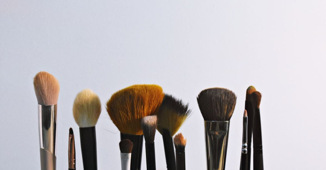 A flatlay of assorted makeup blenders and sponges including egg-shaped, silicone and powder puff types, illustrating a blenders & sponges buying guide.