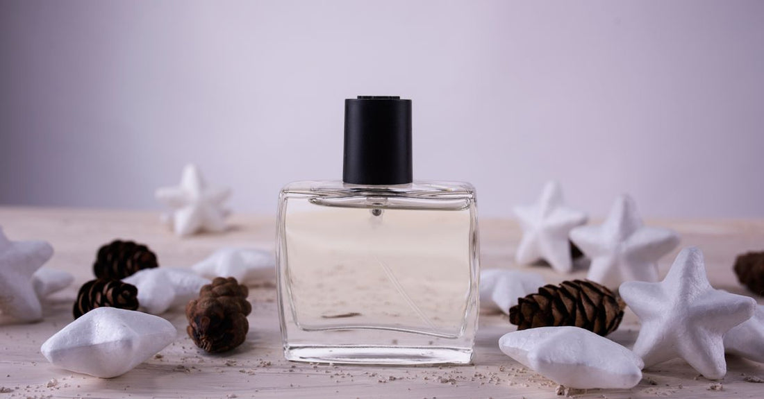 A flatlay of various body spray bottles in a clean, minimalist arrangement, illustrating a body sprays buying guide.