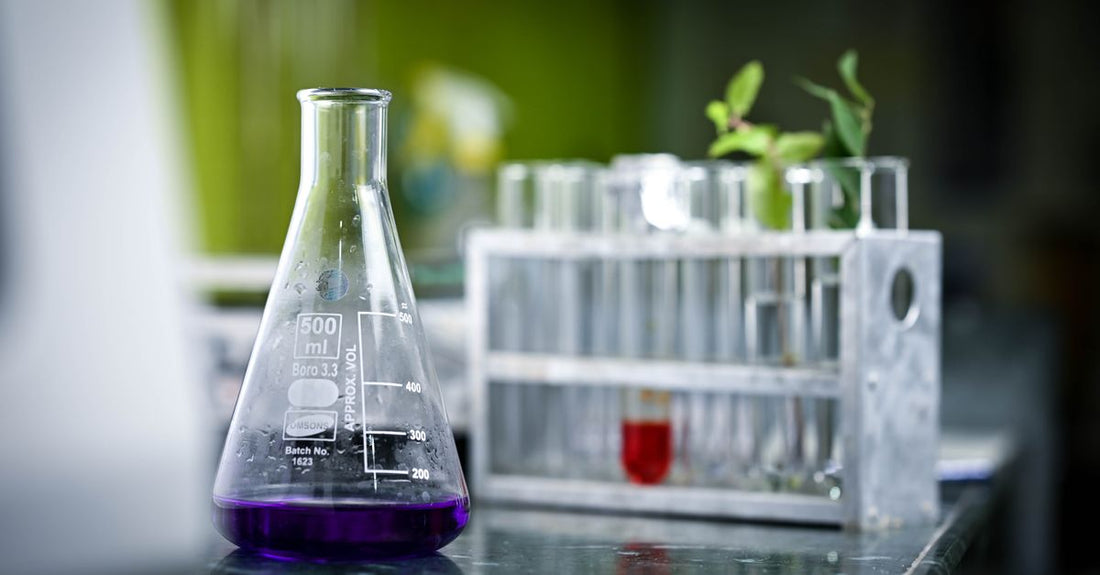 A sleek white bottle of KeraFactor shampoo on a clean laboratory bench, representing kerafactor shampoo for hair growth and scientific hair care.
