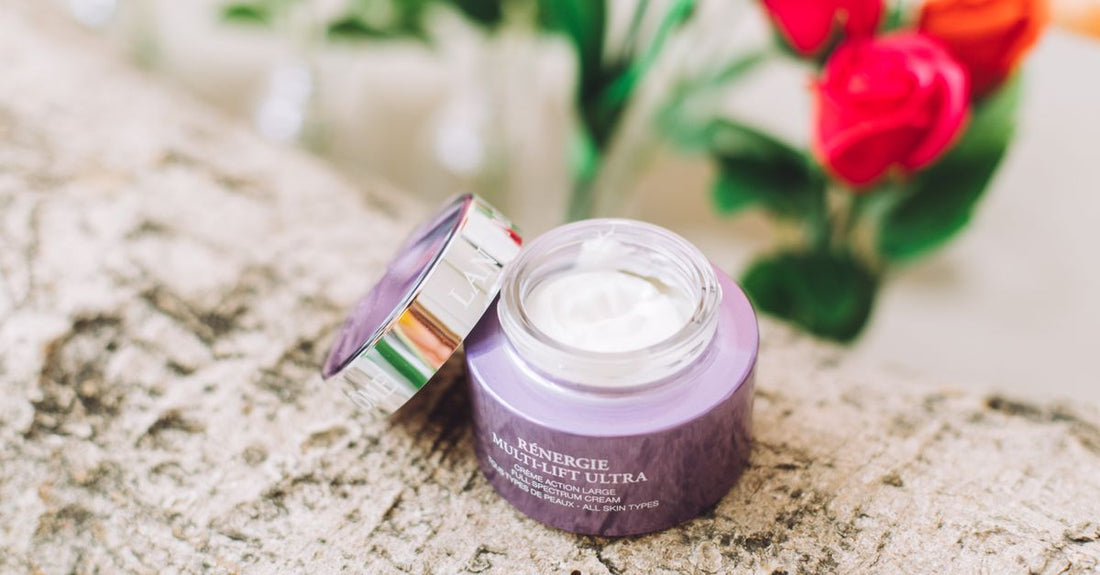 A flatlay arrangement of the best creams and lotions UK 2026, featuring jars and bottles on a marble surface.