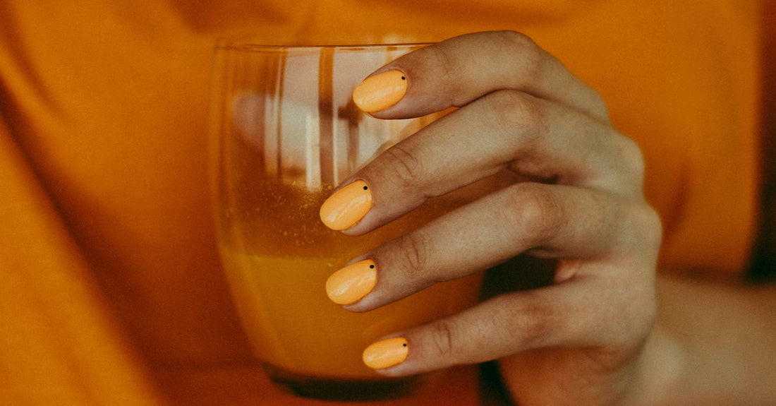 A crystal glass nail file resting on a marble surface, representing the best nail files & buffers 2026 for a smooth, snag-free finish.