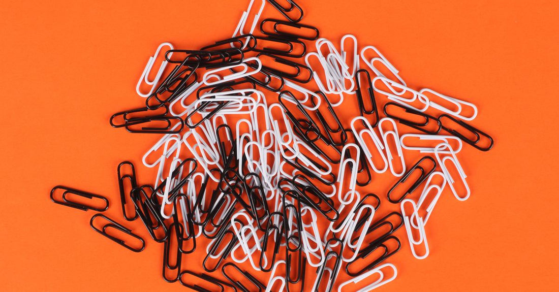 An assortment of colourful claw clips and hair clips laid out on a white surface, illustrating a clips buying guide.