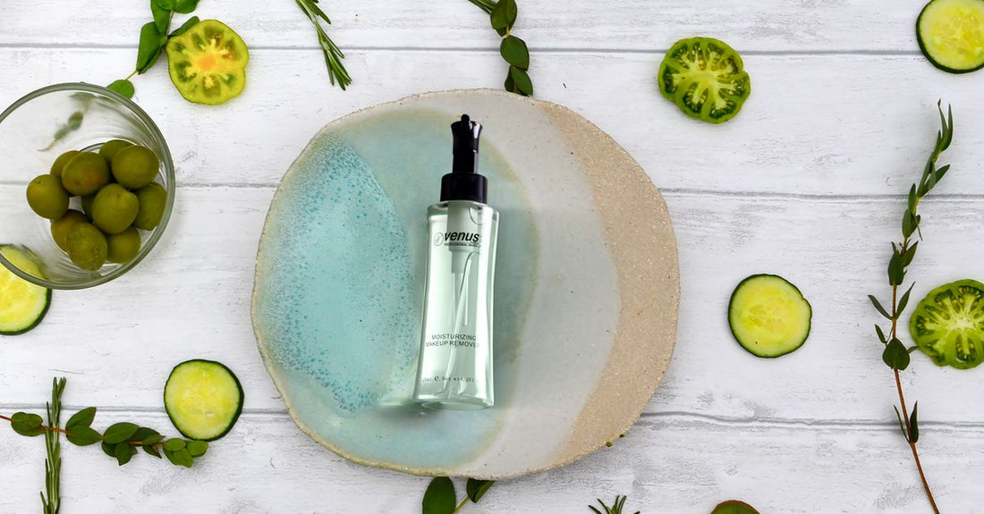 Three glass bottles of makeup cleansing oil on a marble surface, representing a UK buying guide for every skin type.