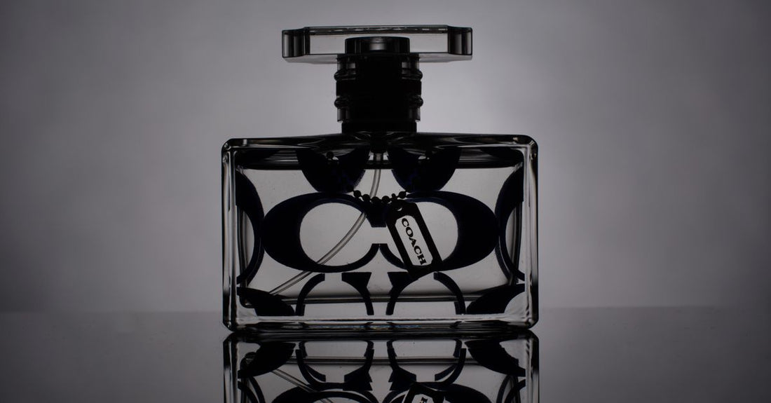 A selection of men's cologne bottles on a marble surface, illustrating our cologne buying guide for UK shoppers.