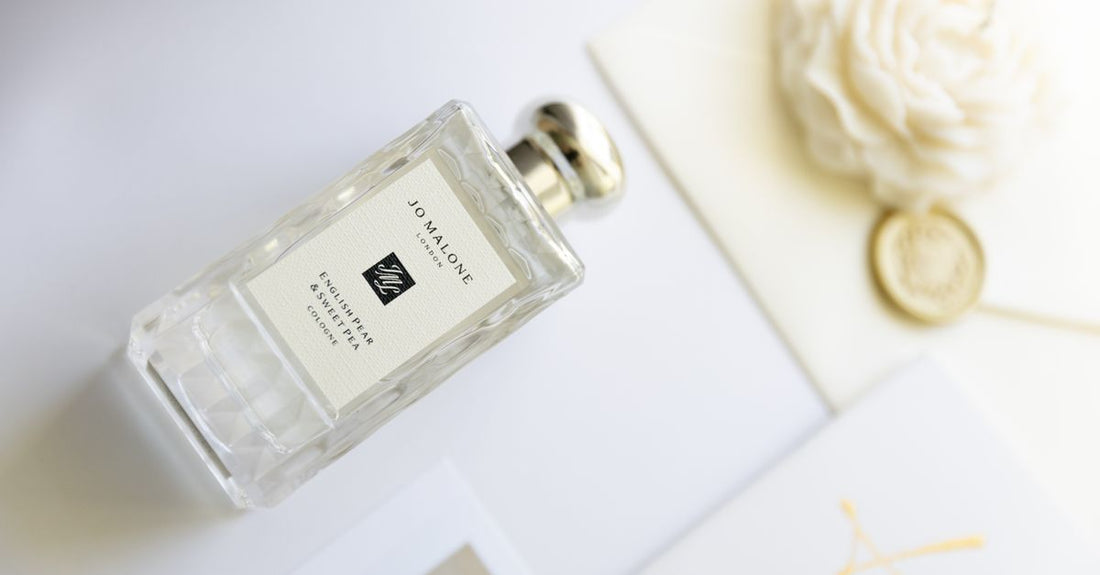 A row of designer cologne bottles on a sleek display shelf, representing the best cologne 2026 options.