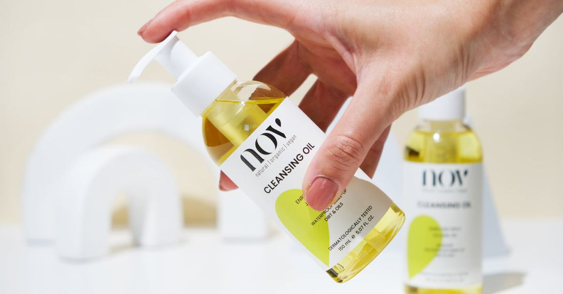 A glass bottle of makeup cleansing oil on a light background, illustrating how to choose makeup cleansing oils UK.