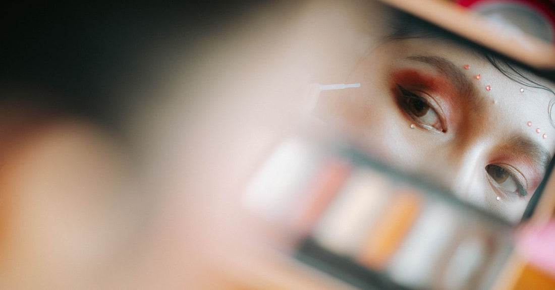 Flatlay of five eyebrow colour products including powder duo, tinted gel, and pencil on a marble surface, representing the best eyebrow color 2026 selection.