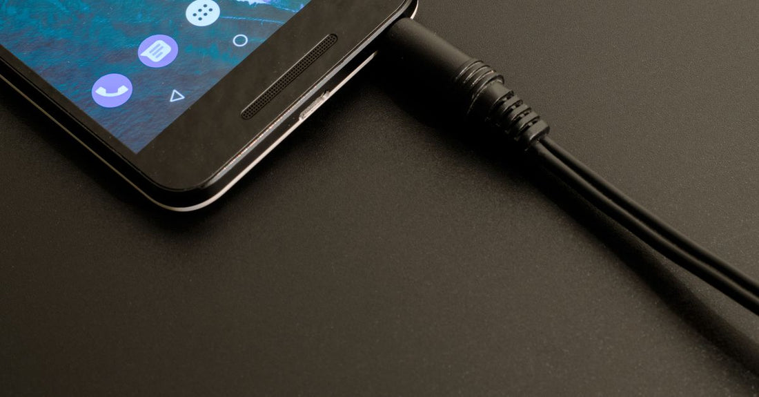A coiled shaver charger cable next to a trimmer on a clean surface, illustrating an accessories buying guide for UK shoppers.