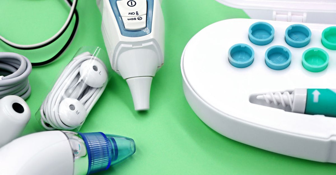 A flatlay of hair wax removal products including oil-based cleansers and wax remover bottles on a light background, illustrating how to remove hair wax at home.