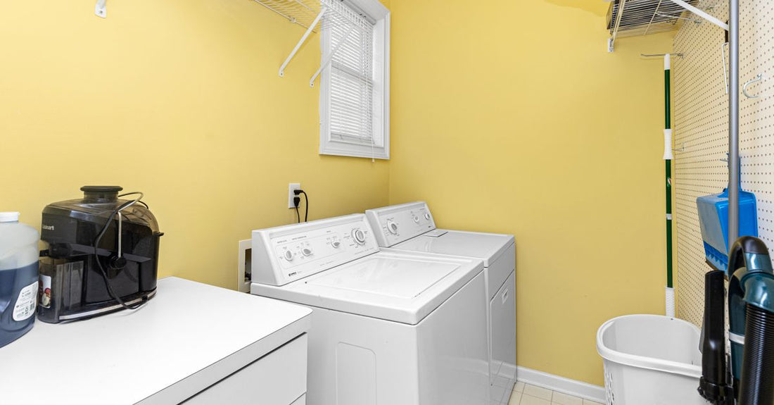 A sleek black hair dryer resting on a modern bathroom shelf, illustrating a hair dryers buying guide for UK routines.